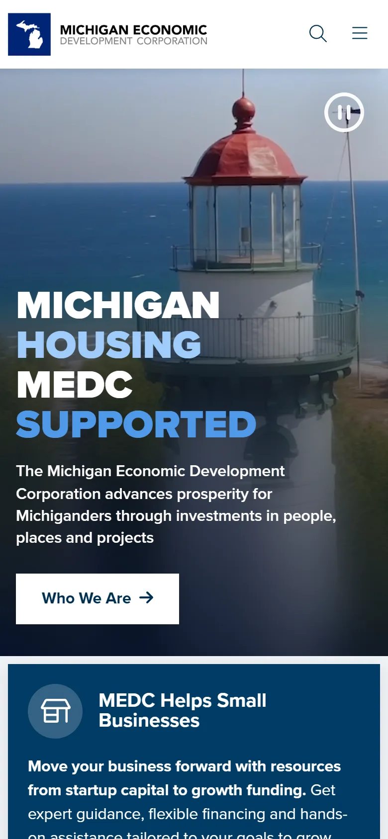 Michigan Business homepage at phone width: the same lighthouse video hero with the headline stacked, the Who We Are button, and the first call-to-action card below.